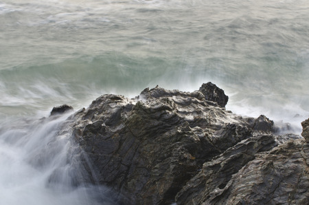 Water waves on rocks at a beachの写真素材