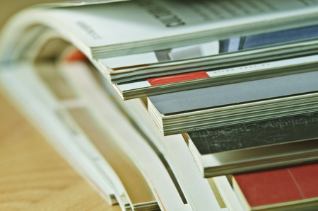 Some magazines on wooden table.の写真素材