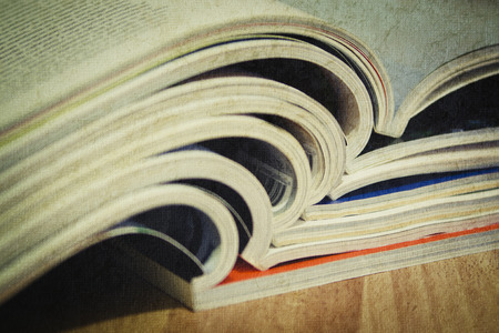 Some magazines on wooden table.の写真素材