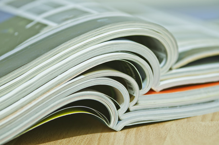 Some magazines on wooden table.の写真素材