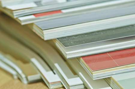 Some magazines on wooden table.の写真素材