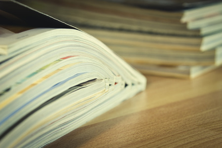 Some magazines on wooden table.の写真素材