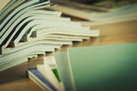 Some magazines on wooden table.の写真素材