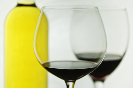 Glasses of red wine and bottle of white wine.の写真素材