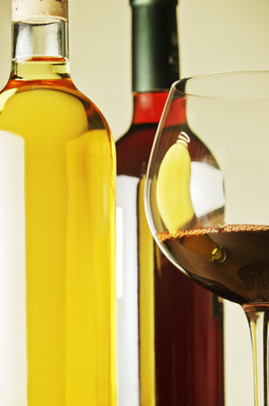 White and red wine bottles and glasses.の写真素材