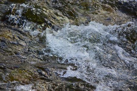 Abstract flowing water river stone curves backgroundの写真素材
