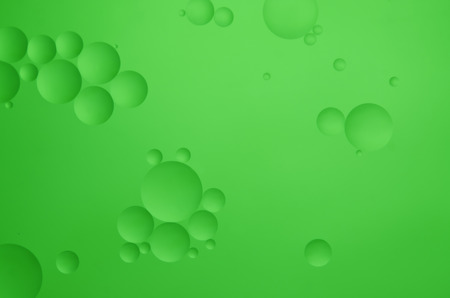 Oil drops in water on a coloured backgroundの写真素材