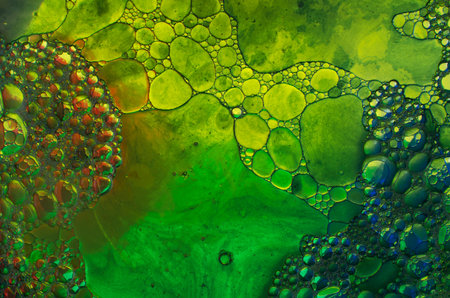 Oil drops in water on a coloured background