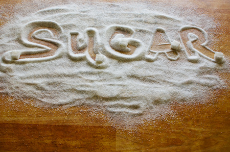 Inscription sugar made into pile of white granulated sugarの写真素材