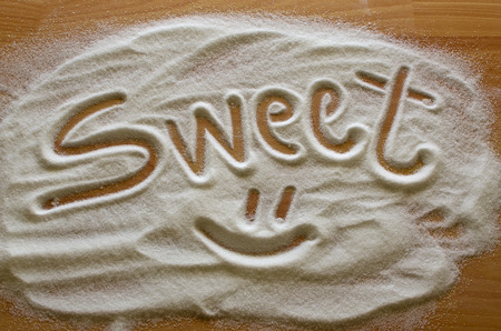 Inscription sweet made into pile of white granulated sugarの写真素材
