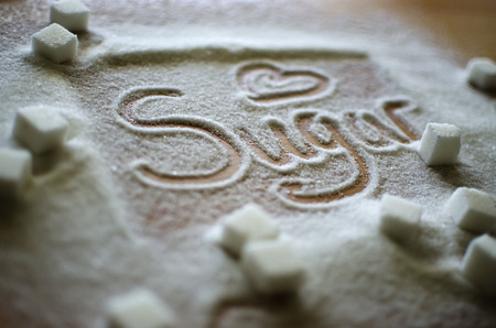 Inscription sugar made into pile of white granulated sugarの写真素材