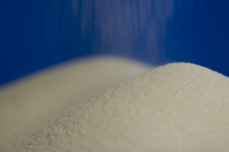 sugar dunes and strewing sugar on blue background.の写真素材