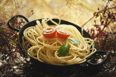 A bowl of pasta with tomatoの写真素材