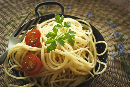 A bowl of pasta with tomatoの写真素材