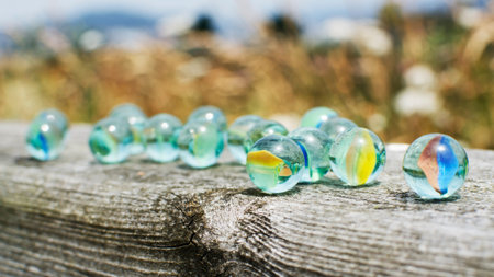 Glass marbles on wood.