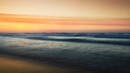 Abstract waves in coast at sunsetの写真素材