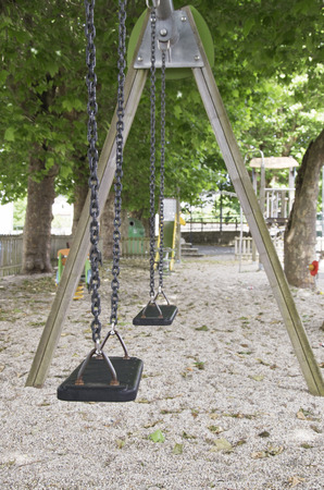 Empty swing on a park at morningの写真素材
