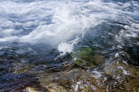 creek flowing over the rocksの写真素材
