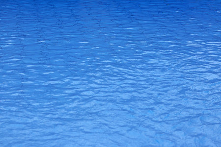 Blue swimming pool water with ripples, close-up of photo