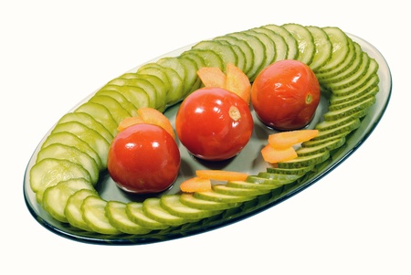 Marinated tomatoes and cucumbers in a bowl on white backgroundの写真素材