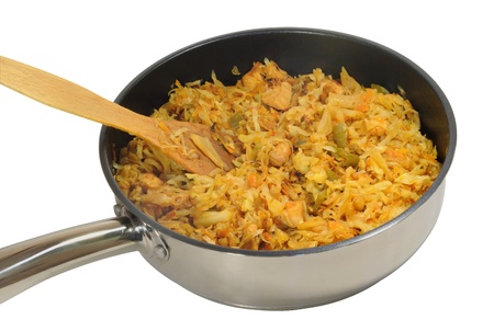 Bigos dish of cabbage and meat. In a frying pan on a white backgroundの写真素材