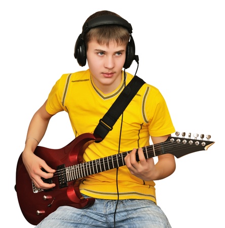 Young man playing electric guitar, looking to go publicの写真素材