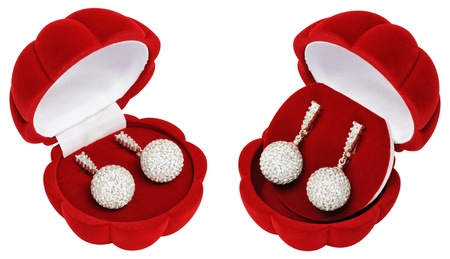 Silver earrings in the form of balls with sparkling crystals. A collage made up of two images from different anglesの写真素材