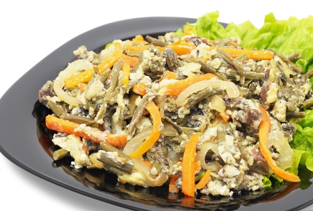 Hot starter - a salad of bracken, carrots, onions, veal with the addition of eggsの写真素材