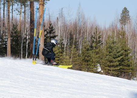 Winter sports. A boy skiing on the roadの写真素材