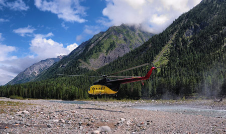 Flying a helicopter in horizontal flight mode at low altitude over the valley of a mountain river....