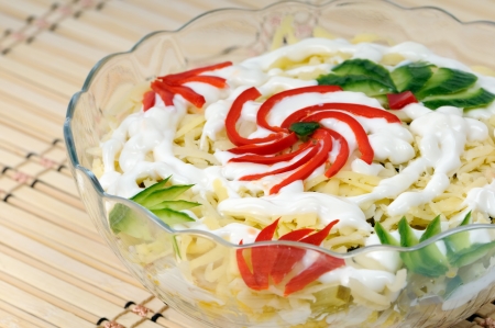 Beautifully decorated festive salad of hard cheese and vegetablesの写真素材