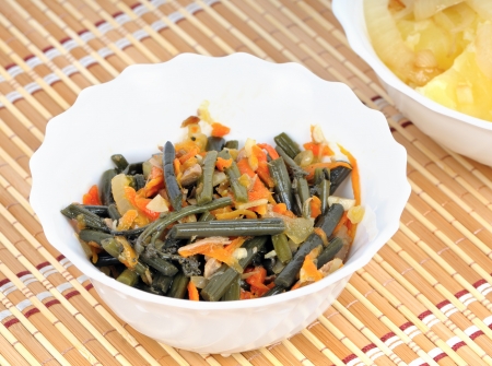 Cold appetizer of bracken fern in white salad bowlの写真素材