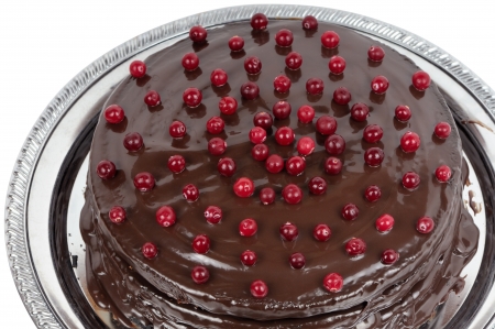 Homemade chocolate cake on a metal round dish. Isolated on whiteの写真素材