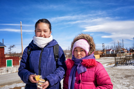 KHANKH, MONGOLIA - March 11, 2016: Modern Mongolian children . Two little girls go to school in village schoolのeditorial素材