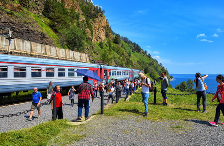 KIRKIREY, IRKUTSK REGION, RUSSIA - July, 29,2016: Baikal Express. Tourists from different countries visiting sights of Circum-Baikal Railway. Stopping 123 kilometer - a place of joining Trans-Siberian Railway in 1904のeditorial素材