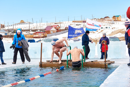 SAHYURTA ,IRKUTSK REGION, RUSSIA - March 11.2017: Cup of Baikal. Winter Swimming. Butterfly 25 meters. Men getting ready for startのeditorial素材