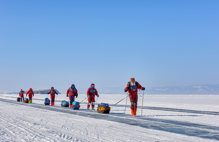 LAKE BAIKAL, IRKUTSK REGION, RUSSIA - March 08, 2017: Expedition on ice of Baikal to test Arctic equipment in low temperature conditions. A group of researchers are skatingのeditorial素材