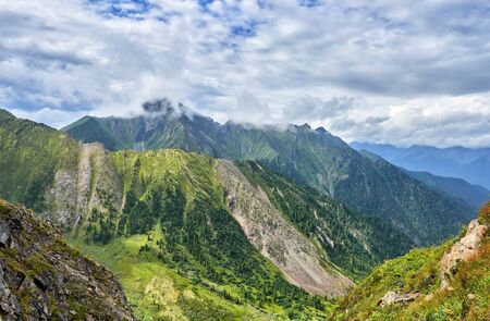 Overcast clouds over mountain rangesの写真素材