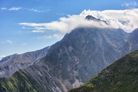 White clouds caught on to peak. Sayan mountains. Eastern Siberia. Russiaの写真素材