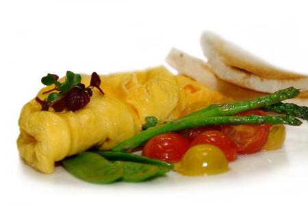Omelet with asparagus and vegetables on white backgroundの写真素材