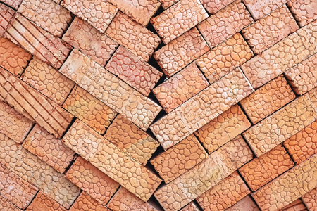 Brown bricks folded into a pile, a background from bricks. Building materialの写真素材