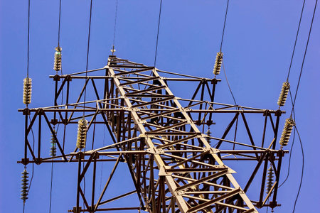 High voltage tower. Electric pole on blue sky background