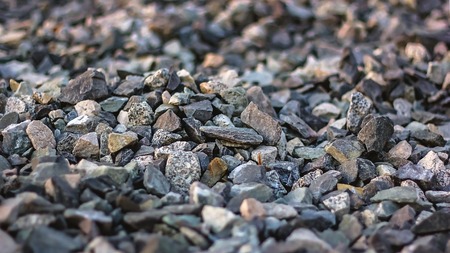 Building stones of grey on the road, close-up, small rocks or gravel used for construction of buildingsの写真素材
