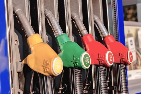 petrol filling gun close-up at the gas station in the daytimeの写真素材