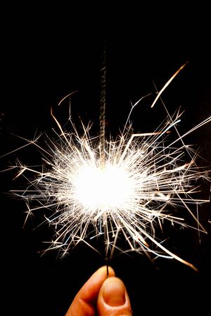 lose-up of bright Bengal lights on black background, Happy holiday, New year and Christmas.の写真素材