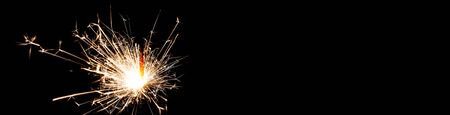 Christmas banner for websites with sparklers on black background with space for text. Happy New year.の写真素材