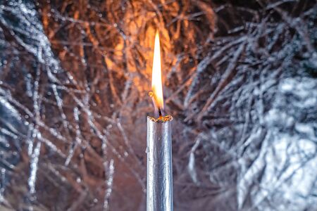 One candle is gray on a gray shiny background macroの写真素材