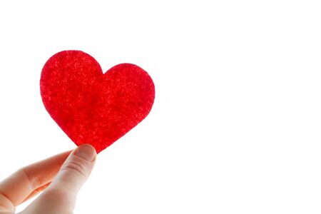 Happy Valentine's day. February 14. Red heart in hand on a white background close-up. Space for text.の写真素材