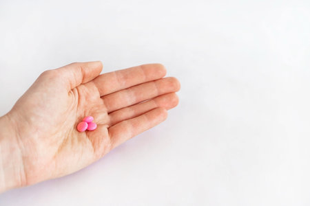 To take the pill, take the pain meds. Tablets in hand on a white background close-up and blurred...