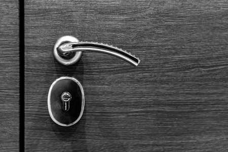 Door lock on a metal door close-up. The new lock on the door is large.